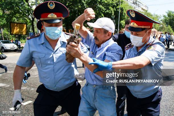 Kazakh police detain a demonstrator on June 6, 2020 in Almaty during a demonstration called by political opposition groups Democratic Choice of...