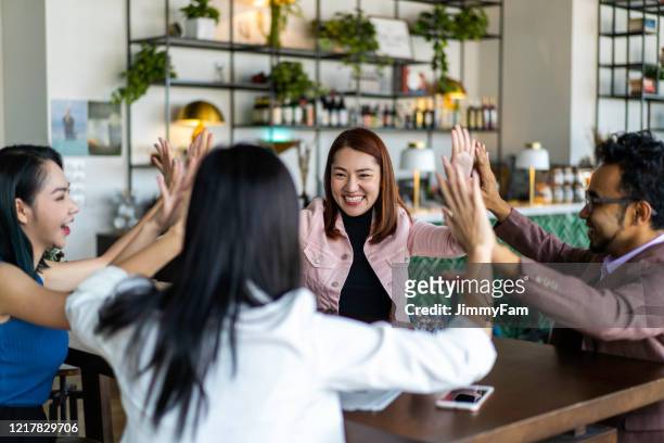 asians millennials congratulating each other for job well done. - all the time stock pictures, royalty-free photos & images