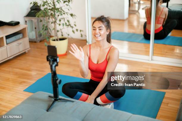 beautiful woman teaching from home using a video chat - tripod stock pictures, royalty-free photos & images