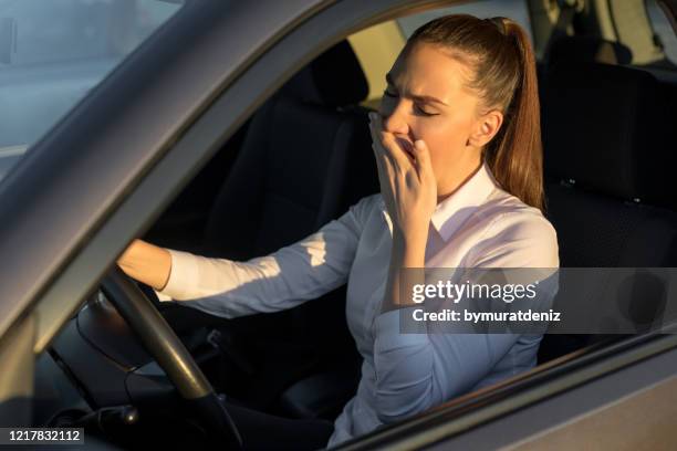 müde frau, die ein auto fährt - safe driving stock-fotos und bilder