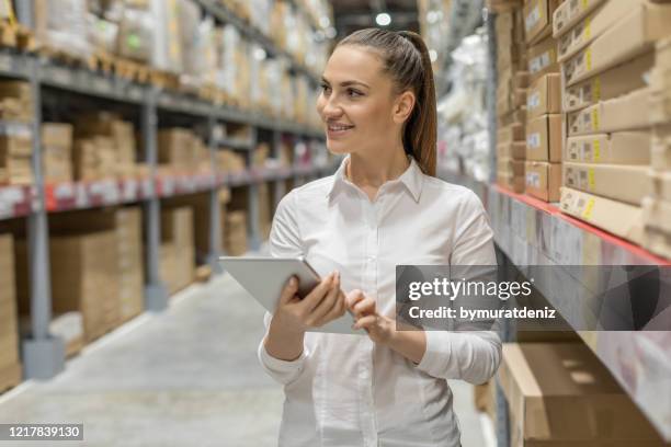 young woman auditor working in warehouse store - demanding boss stock pictures, royalty-free photos & images