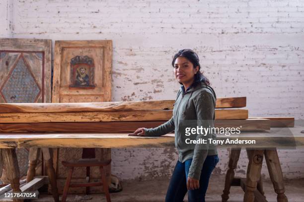 Young woman working at artisanal furniture workshop