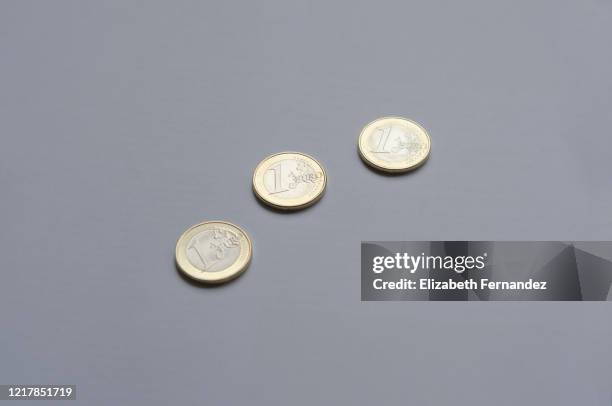 euro coins - one euro coin stock pictures, royalty-free photos & images