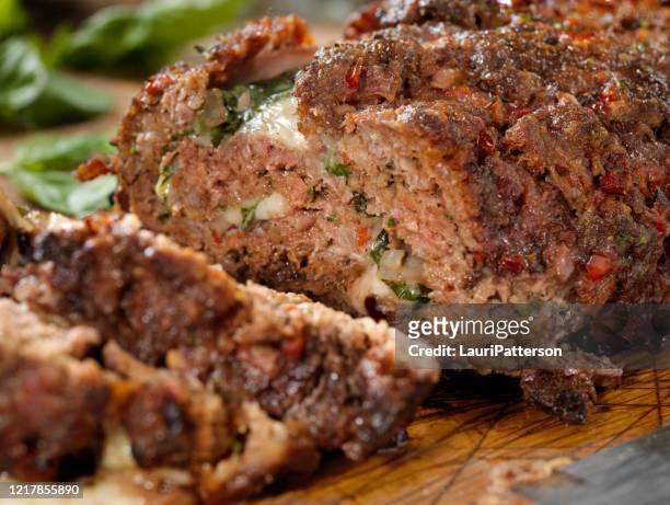 sicilian style rolled meatloaf with deli ham, basil and mozzarella - meatloaf stock pictures, royalty-free photos & images