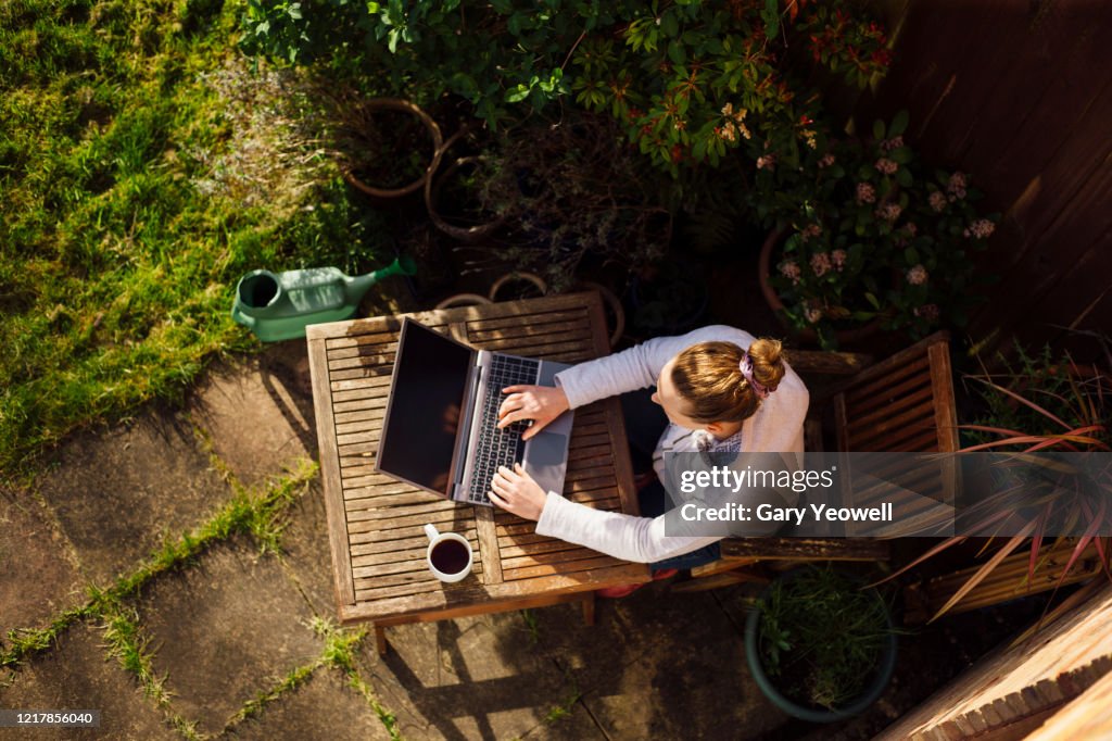 Woman working from home in her garden