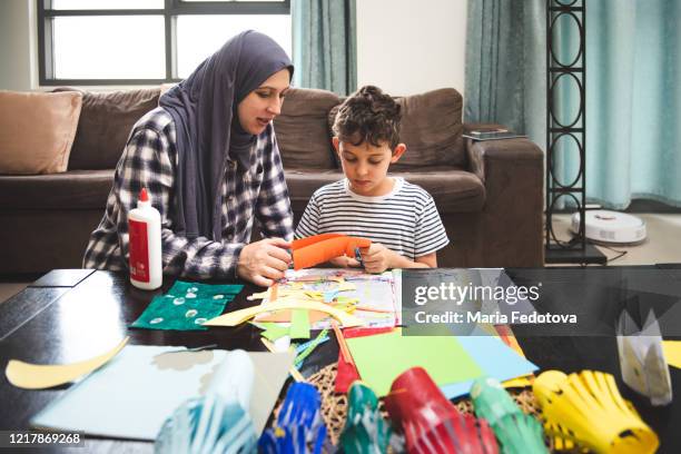 mother and child doing creative activities together - lantern ramadan stock pictures, royalty-free photos & images