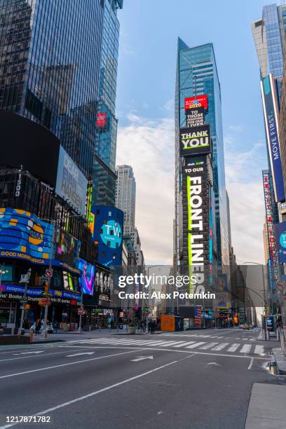 times square commercials on the main plaza display are now replaced with social advertising influenced by covid-19 pandemic outbreak, thanking front liners. - broadway bares stock pictures, royalty-free photos & images