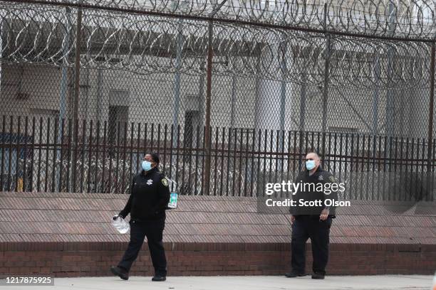 People wearing protective masks leave the Cook County jail complex on April 09, 2020 in Chicago, Illinois. With nearly 400 cases of COVID-19 having...