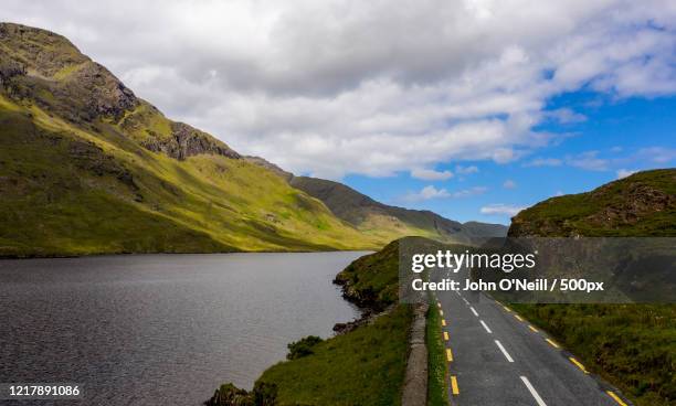 landscape with road along lake and mountains, wild atlantic way, westport, county mayo, ireland - wild atlantic way stock pictures, royalty-free photos & images