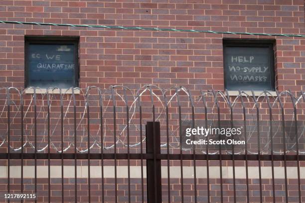 Signs pleading for help hang in windows at the Cook County jail complex on April 09, 2020 in Chicago, Illinois. With nearly 400 cases of COVID-19...