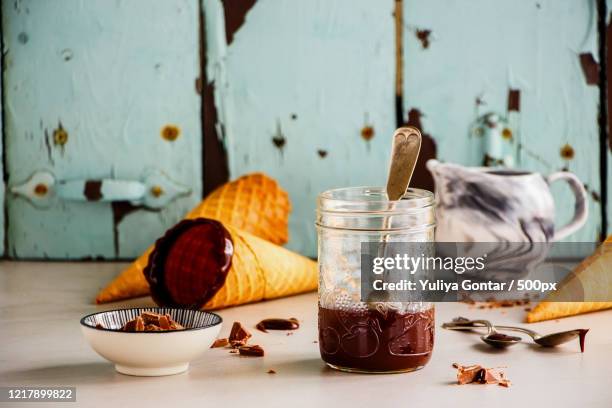 melted chocolate in jar - glace cornet stock pictures, royalty-free photos & images