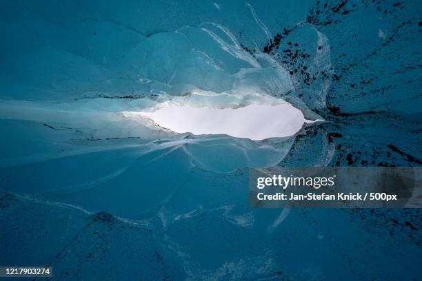 hole in ice cave - jan stefan knick stockfoto's en -beelden