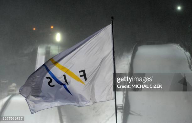 This picture taken on December 2010 at the Harrachov's ski jump hill shows a flag of International Ski Federation blowing in the wind as the FIS Ski...