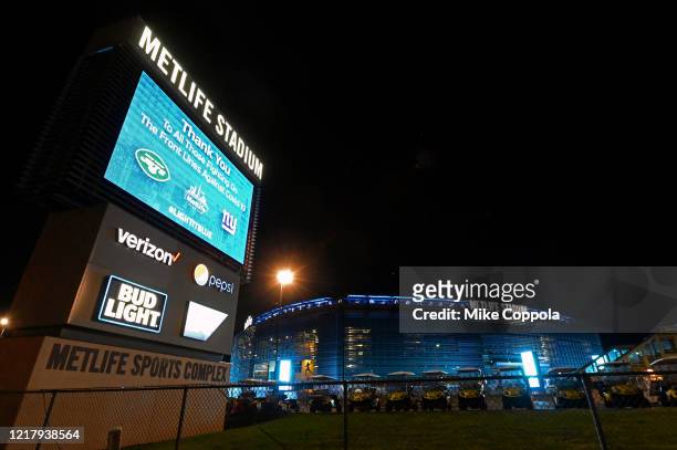 Metlife Stadium is illuminated in blue to honor essential workers on April 09, 2020 in East Rutherford, New Jersey. Landmarks and buildings across...