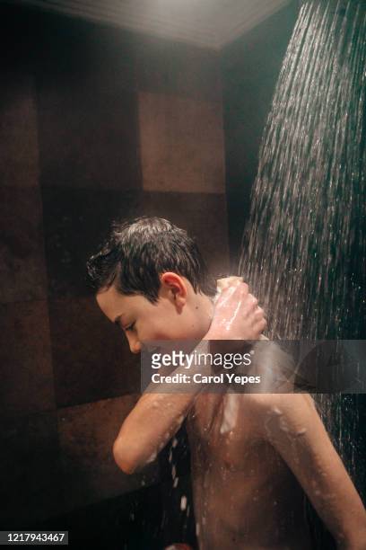 teen boy enjoying shower - boy taking a shower stock-fotos und bilder