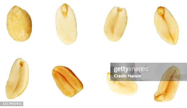 close-up of peanuts against white background - salted stock-fotos und bilder