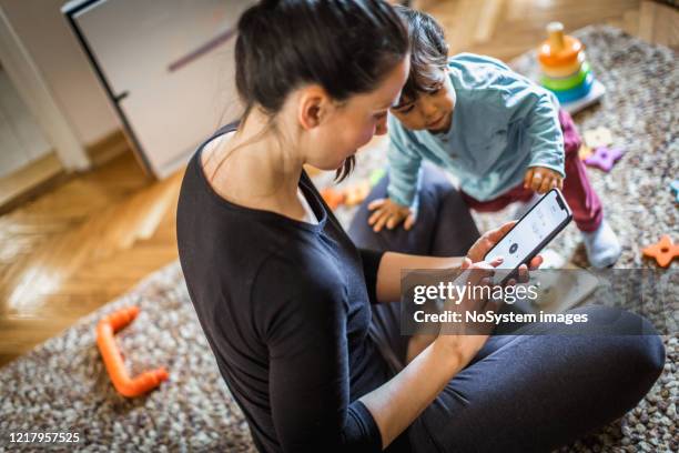 woman exercising at home, using mobile app - child yoga elevated view stock pictures, royalty-free photos & images