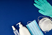 Flat lay of Coronavirus protection, medical protective masks, gloves, hand sanitizer bottles