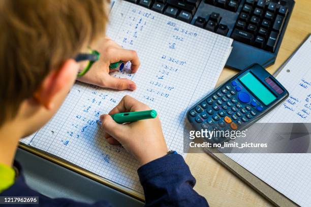 teenager doing homework in his room - mathematics stock pictures, royalty-free photos & images