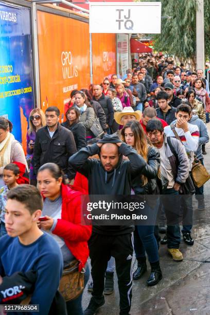 hundreds of people wait in line to cross the us-mexico border at the san ysidro port of entry in tijuana - pedestrian overpass stock pictures, royalty-free photos & images