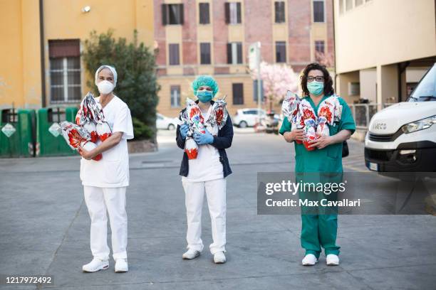 Sant'Orsola Hospital's team, in partnership with Ferrero, pose as they are about to distribute chocolate eggs for Easter to all employees including...