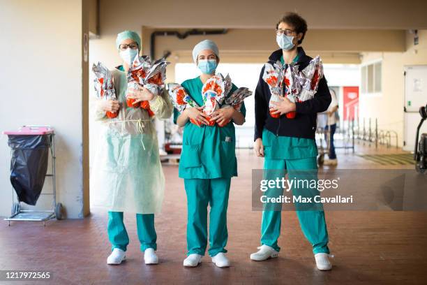 Sant'Orsola Hospital's team, in partnership with Ferrero, pose as they are about to distribute chocolate eggs for Easter to all employees including...