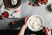 Female chef mixing yogurt in a bowl