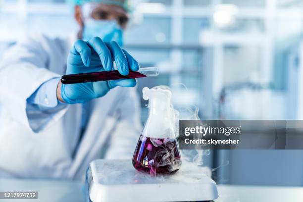 close up of mixing poisonous chemical liquids on a magnetic stirrer. - volume fluid capacity stock pictures, royalty-free photos & images