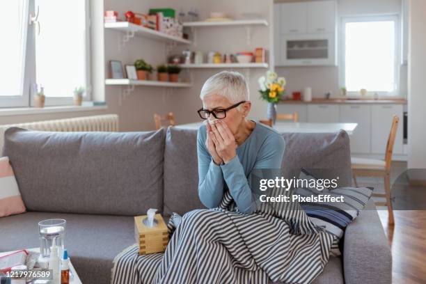 i'm sick again - caucasian woman sick in bed coughing stock pictures, royalty-free photos & images