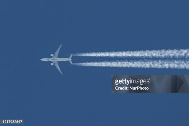 Pakistan International Airlines PIA Boeing 777-300 aircraft as seen flying in the Greek summer blue sky over the city of Thessaloniki in Greece. The...