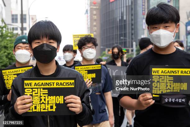 Youth protestors hold Black Lives Matter placards on June 06, 2020 in Seoul, South Korea. The Rally in solidarity with protests in the United States...