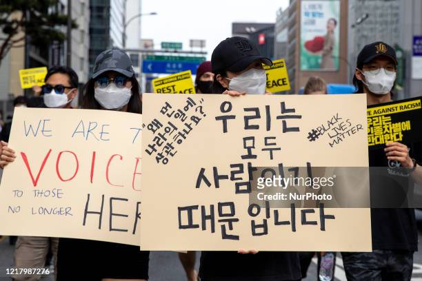 Protestors hold Black Lives Matter placards on June 06, 2020 in Seoul, South Korea. The Rally in solidarity with protests in the United States...