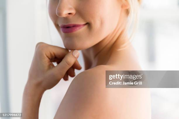 close up of woman's smile and bare shoulder - fossetta foto e immagini stock