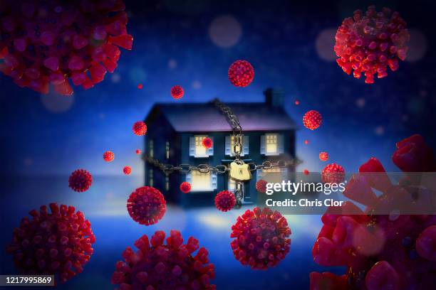 digitally generated image of chained up house surrounded with coronaviruses - kontaminierung stock-grafiken, -clipart, -cartoons und -symbole