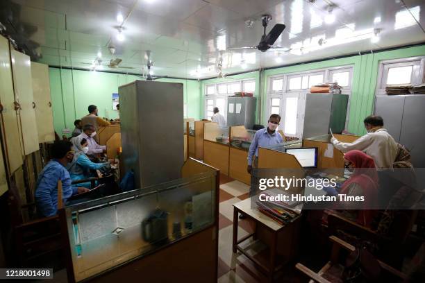 Government employees seen at work after the offices reopened following the ease in lockdown restrictions, in Lal Chowk, on June 6, 2020 in Srinagar,...