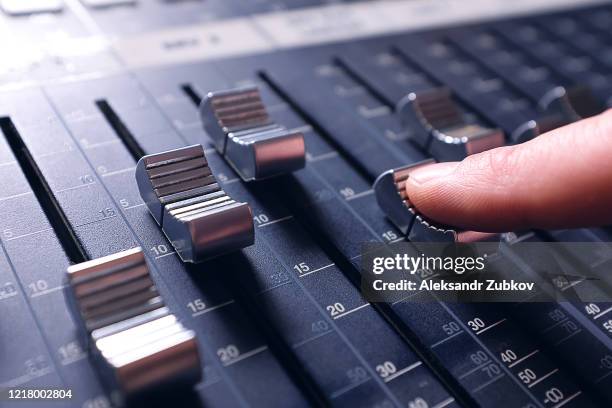 amplifying equipment that adjusts studio audio mixer knobs and faders. workplace and equipment of the sound engineer. acoustic mixing of music, selective focus. banner. - dj console stock pictures, royalty-free photos & images