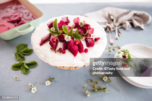 cheesecake with roasted red rhubarb and wild strawberry - rhubarb cheesecake stock pictures, royalty-free photos & images