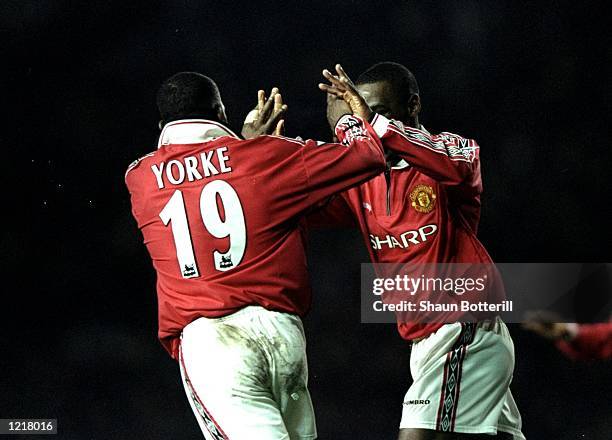 Andy Cole and Dwight Yorke of Manchester United congratulate each other after scoring a goal during the FA Carling Premiership match against West Ham...