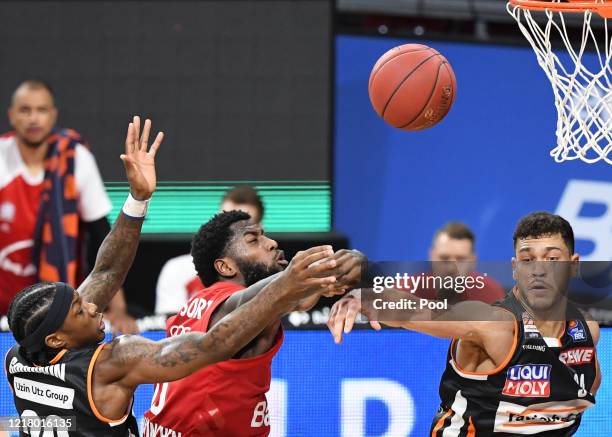 Mathias Lessort of FC Bayern Muenchen is blocked by Archie Goodwin and Gavin Schilling of Ratiopharm Ulm during the EasyCredit Basketball Bundesliga...