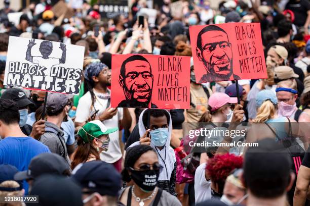 Protesters walk along the recently renamed Black Lives Matter Plaza with signs near the White House during George Floyd protests on June 6, 2020 in...