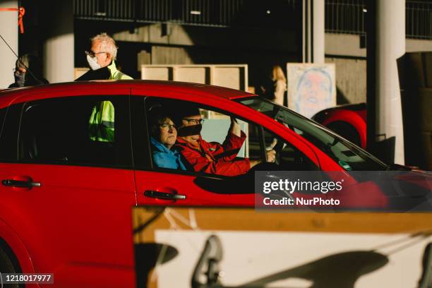 People drive through the show through the parking lot during the opening of drive in Gallery's show "Nachtbroetchen 2.0" at Cologne airport parking...