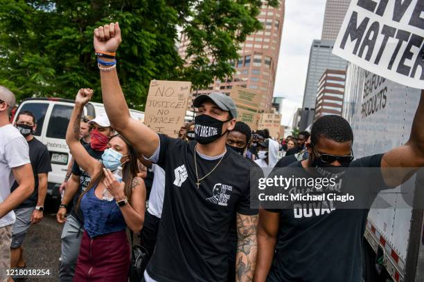 Denver Broncos safety Justin Simmons holds his fist in the air as he marches at a protest for the death of George Floyd on June 6, 2020 in Denver,...