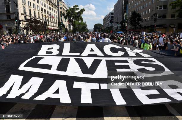 Demonstrators deploy a " Black Lives Matter" banner near the White House during a demonstration against racism and police brutality, in Washington,...