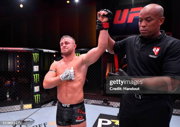 In this handout image provided by UFC, Cody Stamman celebrates after his victory over Brian Kelleher in their featherweight bout during the UFC 250...