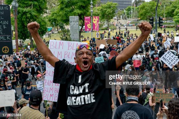 Pedro Chavez shouts toward police officers during a demonstration over the death of George Floyd while in Minneapolis Police custody, in downtown Los...