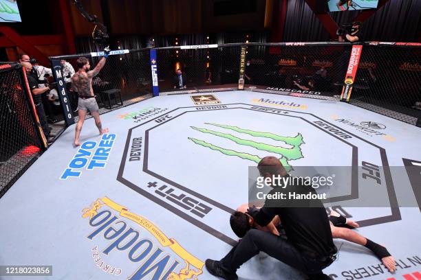 In this handout image provided by UFC, Cody Garbrandt celebrates after his knockout victory over Raphael Assuncao of Brazil in their bantamweight...