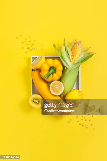 yellow colour vegan food still life image. - flatlay stock-fotos und bilder