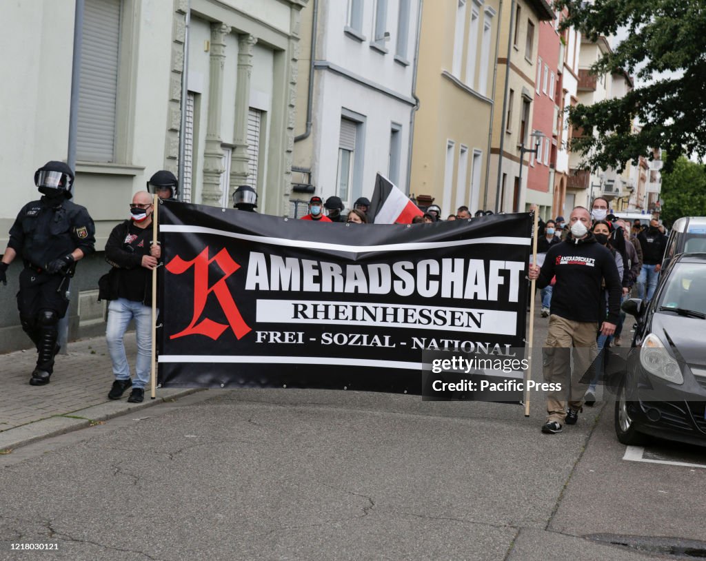 Two right-wing protesters carry a banner that reads...