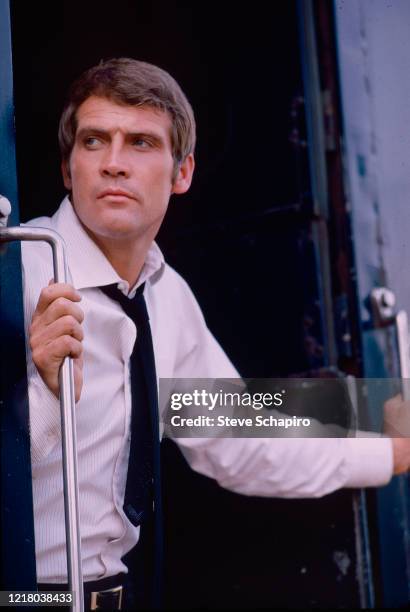 View of American actor Lee Majors as he stands in the open door of a train, 1978.