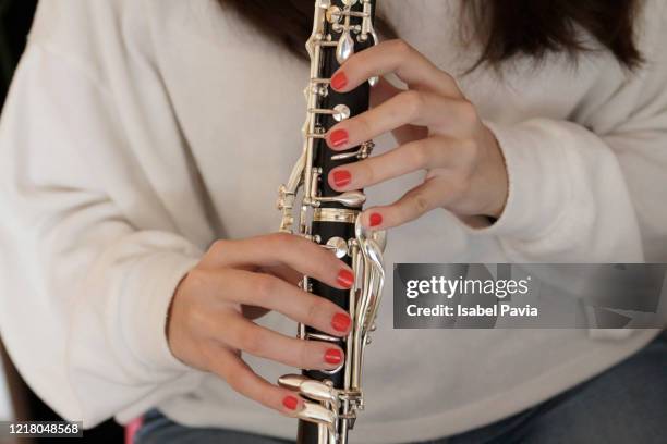close-up of woman playing clarinet - クラリネット ストックフォトと画像